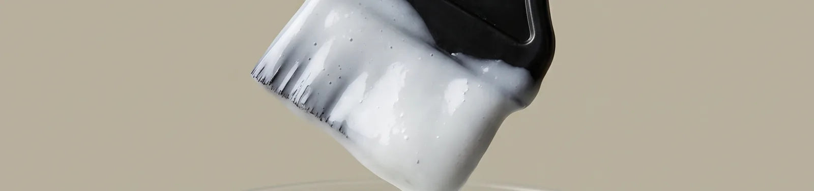 Applicator brush loaded with cream